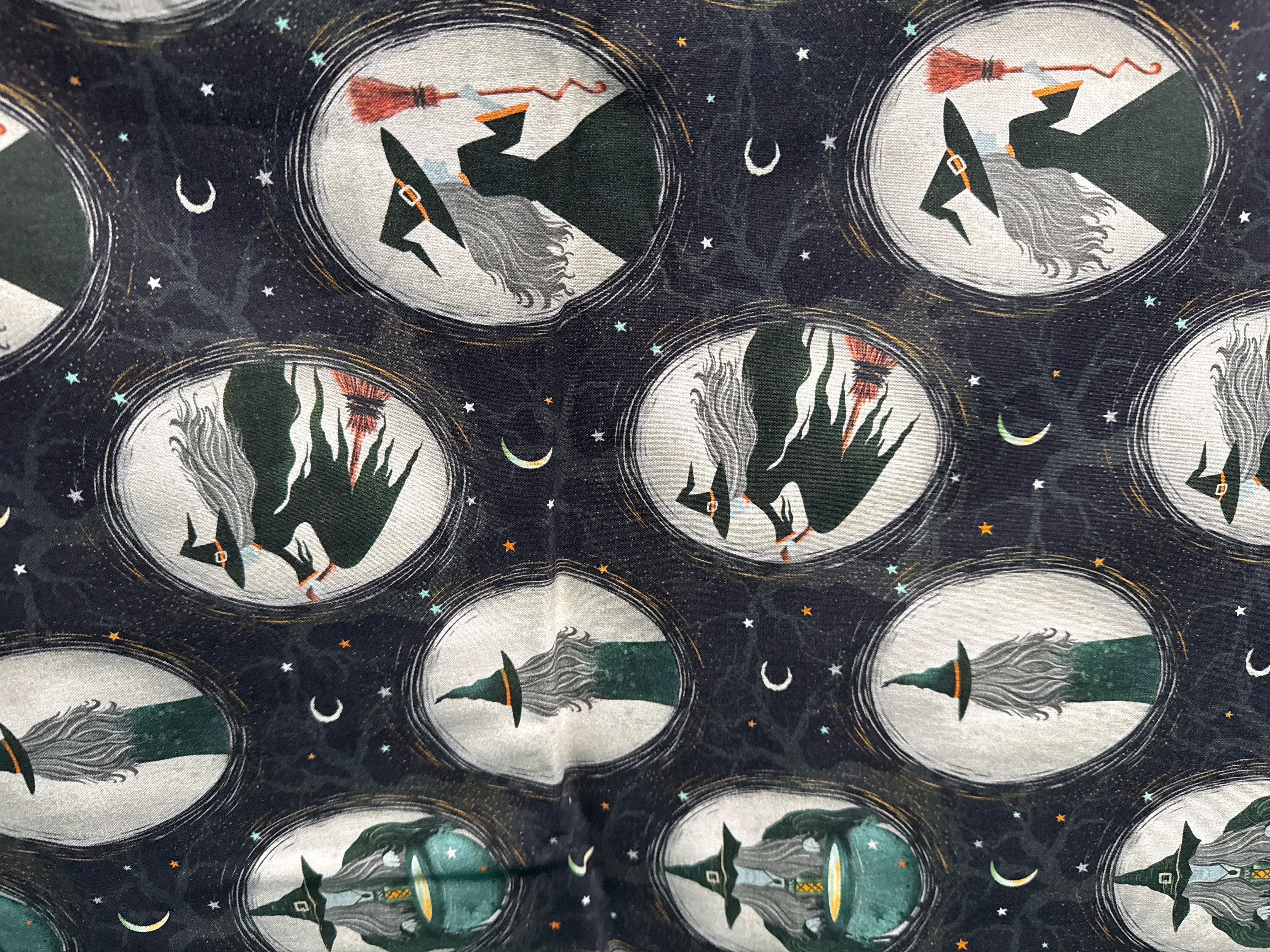 Witchy wicked witches inside of medallions. Sold by the half yard.