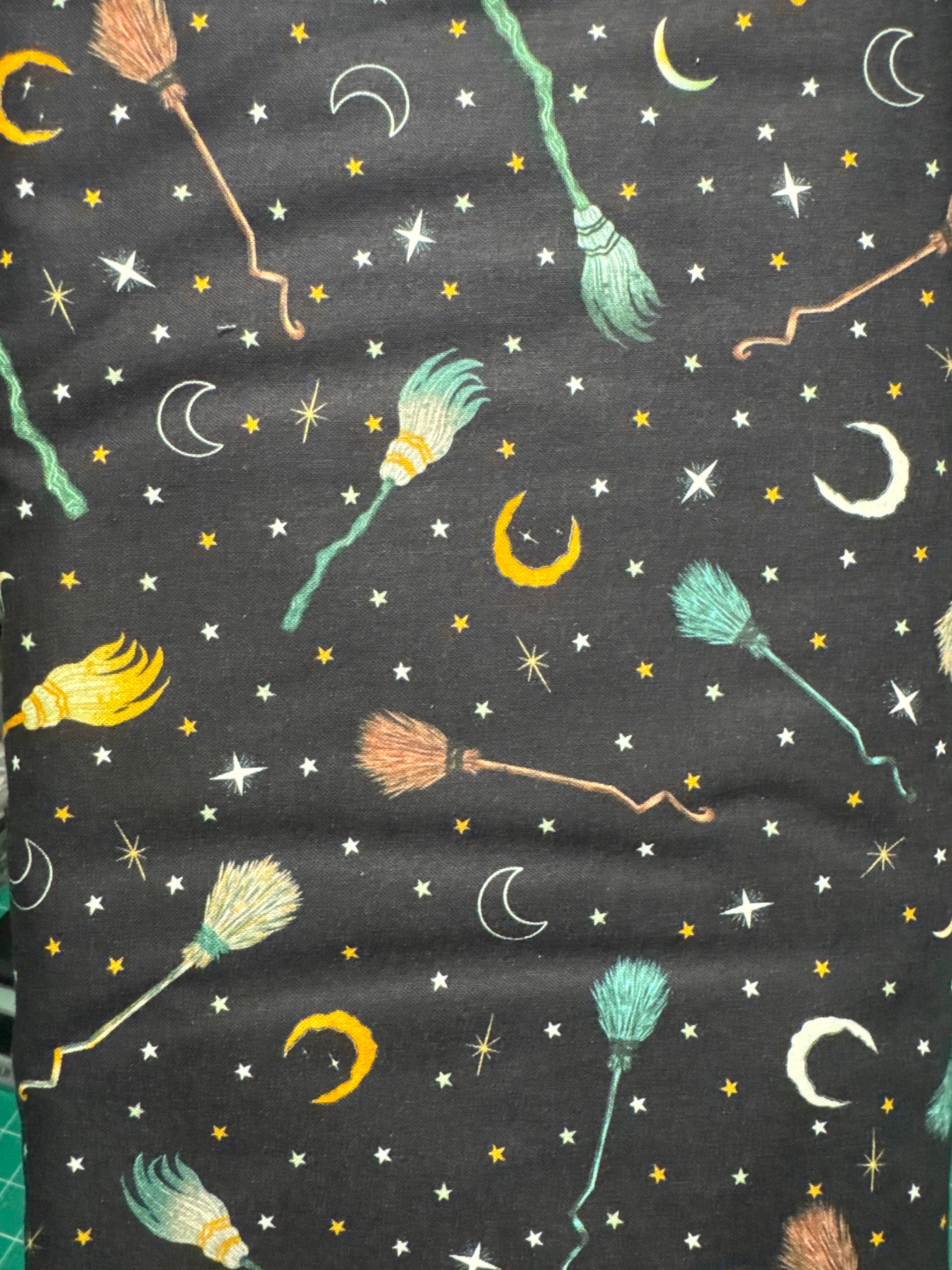 Witchy wicked brooms on a back black ground. Sold by the half yard.