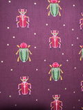 Bird humbug. Bugs on maroon. Sold by the half yard.