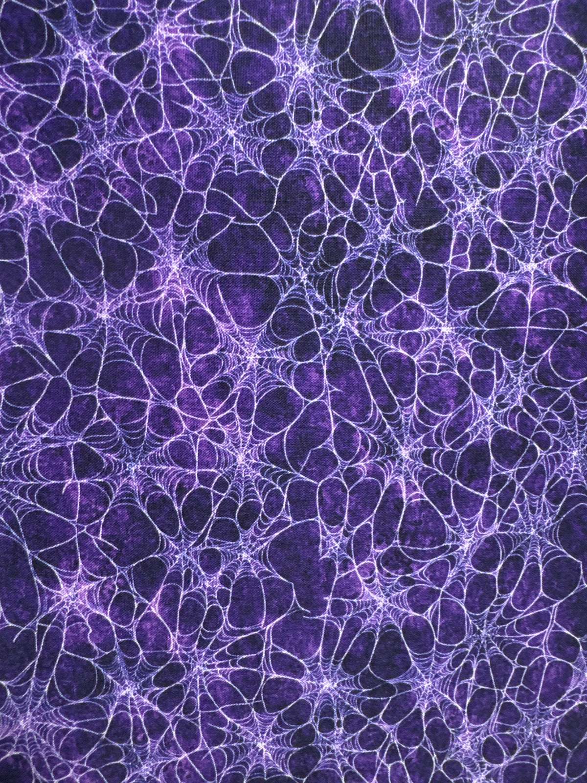 Witchypoo. Spiderwebs on a purple background. Sold by the half yard. ￼