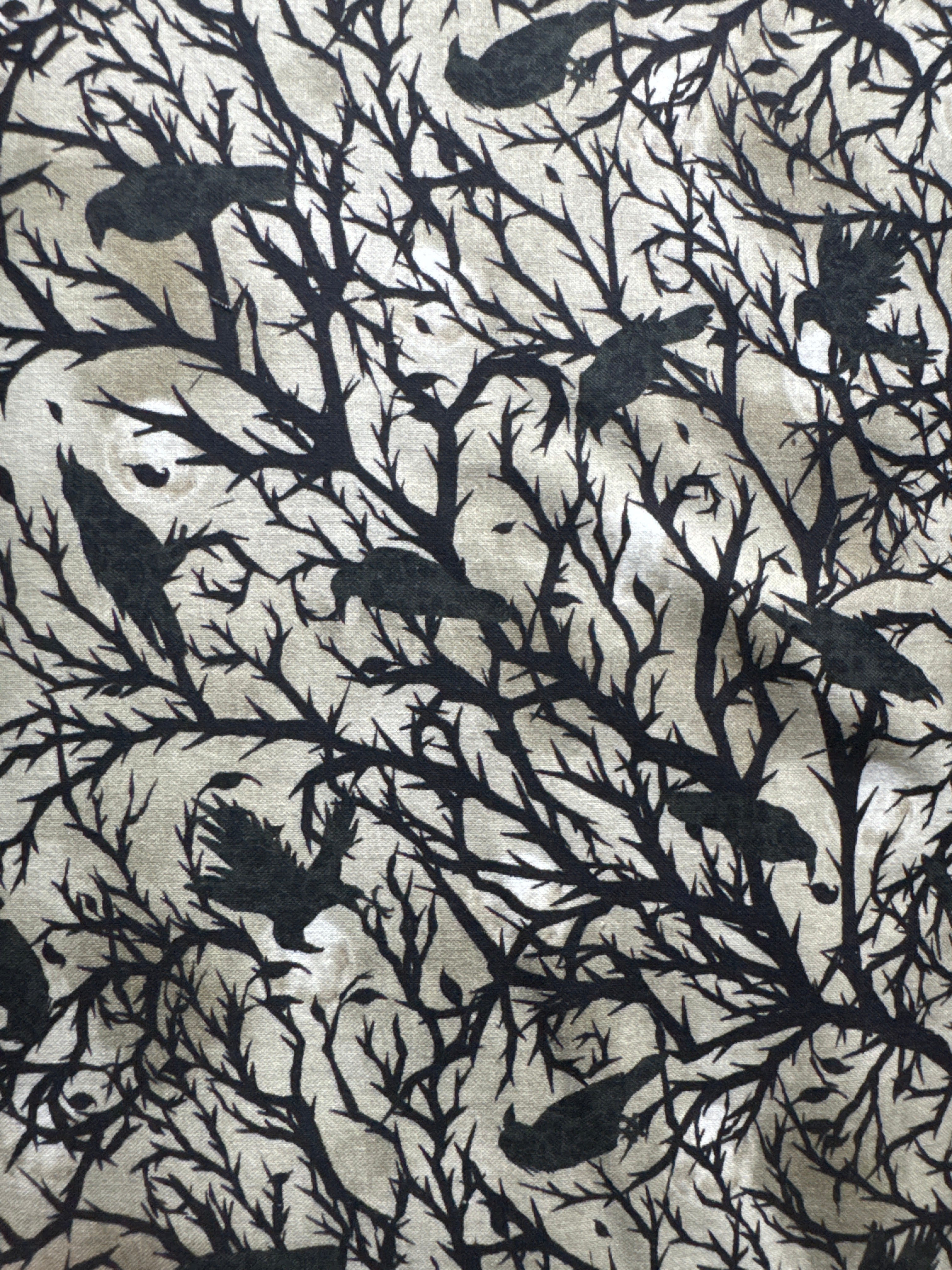 Darkly enchanted. Ravens in trees. Sold by half yard