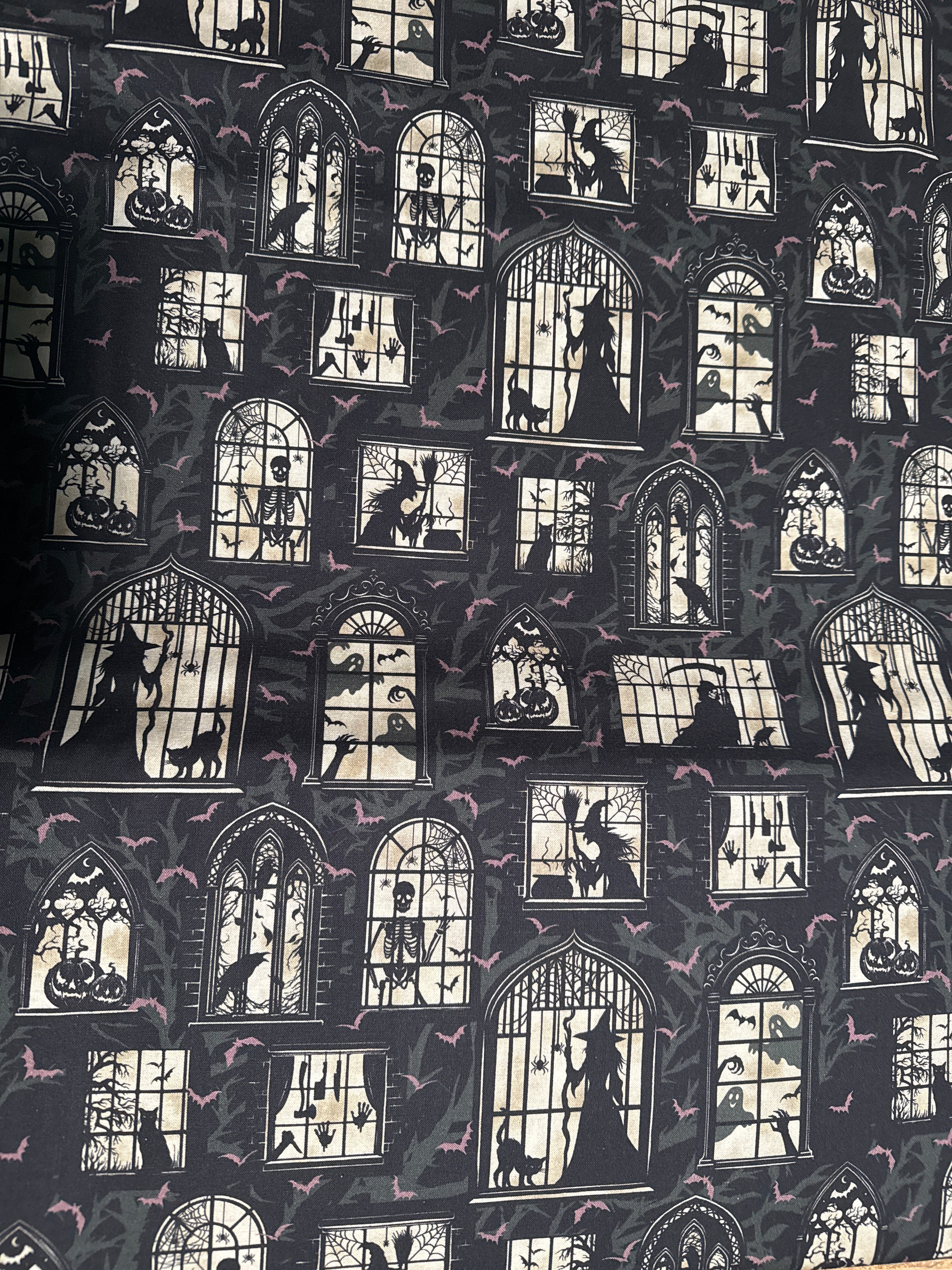 Darkly Enchanted. Mansion windows with spooky silhouettes. Sold by the half yard